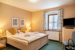 a bedroom with a bed and a tv and a window at Chalet Sonneck - Seefeld in Seefeld in Tirol
