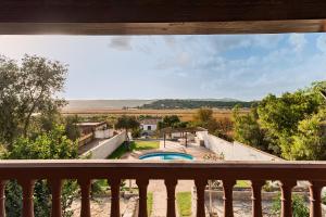 a view of a pool from a balcony at Casa de Piedra in El Cañal