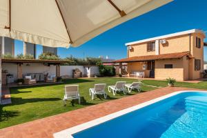 a villa with a swimming pool and a house at Villa Gle in Quartu SantʼElena