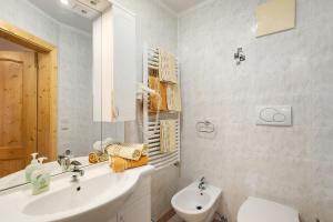 a white bathroom with a sink and a toilet at Burgerhof in Gsies +80 photos