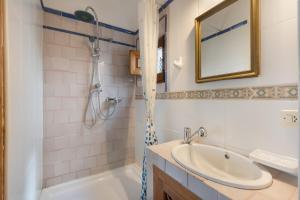 a bathroom with a sink and a shower at Casa de la Fuente in Bubión +27 photos