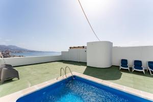 a swimming pool on the roof of a building at Penthouse with private pool in Málaga