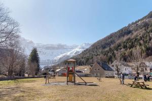 a playground in a park with a snow covered mountain at Cabane Perce Neige - Gavarnie in Gèdre