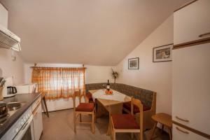a kitchen and dining room with a table and chairs at Ferienwohnung Brugger 4 Personen in Kaltenbach