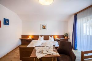 a hotel room with a bed and a table at Ferienwohnung Brugger 4 Personen in Kaltenbach