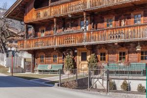 a wooden building with a bench in front of it at Ferienwohnung Brugger 4 Personen in Kaltenbach