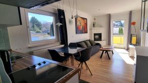 a living room with a couch and a table at Windjammer in Koserow
