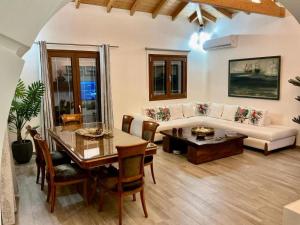 a living room with a table and a couch at Villa Logas Hill in Peroulades