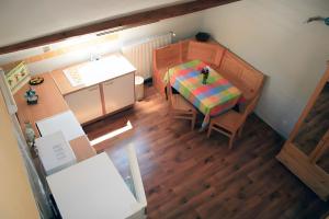 an overhead view of a small kitchen with a table and chairs at La Grange in Doussard