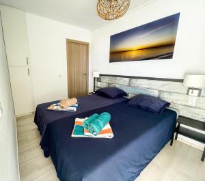 a bedroom with two beds with towels on them at Front Americano in Torrox Costa