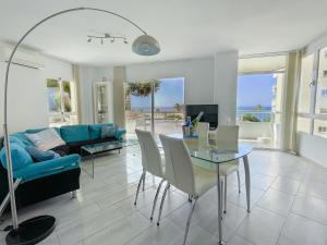 a living room with a table and a blue couch at Front Americano in Torrox Costa