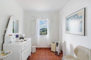 a white room with a desk and a window at Sunset Cliffs By Slice Of Heaven in Ribeira Brava +25 photos