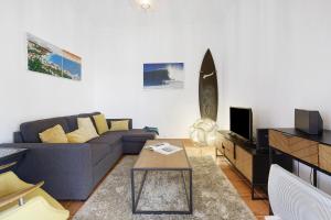 a living room with a couch and a table at Sunset Cliffs By Slice Of Heaven in Ribeira Brava