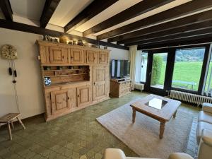 a living room with wooden cabinets and a table at Ferienhaus Hochtal in Bernau im Schwarzwald