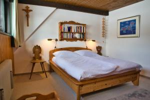 a bedroom with a bed with a book shelf at Ferienhaus Hochtal in Bernau im Schwarzwald
