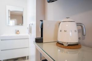 a mixer sitting on a counter in a kitchen at Orange Blossom Grove in São Bartolomeu de Messines +46 photos