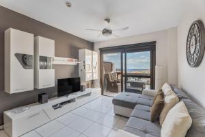 a living room with a couch and a tv at Cathamarcella in San Miguel de Abona