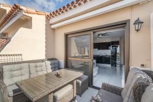 a patio with a table and a couch at Cathamarcella in San Miguel de Abona