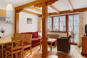 a living room with a red couch and a table at Ferienhaus Schwörer in Feldberg