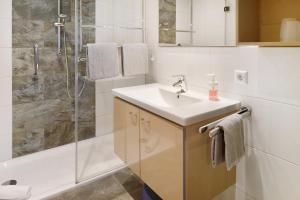 a white bathroom with a sink and a shower at Ferienhaus Schwörer in Feldberg +76 photos