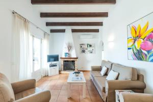 a living room with a couch and a fireplace at Villa Mariola in Sant Lluis