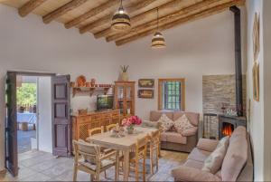 a living room with a table and a fireplace at Casa Rural Monte Dios in Jubrique