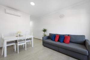 a living room with a couch and a table at Victoria's House in Sagres
