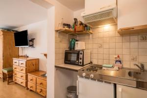 a kitchen with a sink and a microwave at Ferienwohnung Achraintal 4 in Lindau +17 photos