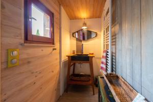 a small bathroom with a sink and a wooden wall at Eco Chalet - Terrasses et sauna in Sospel +34 photos