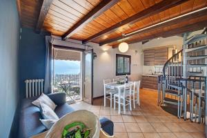 a living room with a couch and a table and a kitchen at Crotto Palma in Dongo