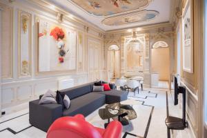 a living room with a couch and a table at Palacio Salvetti Suites in Alicante