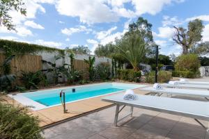 a swimming pool in a yard with a table and a bench at Water Run in Bari