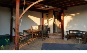 a patio with a table and chairs and a grill at Ferienwohnung Seilerberg in Freiberg