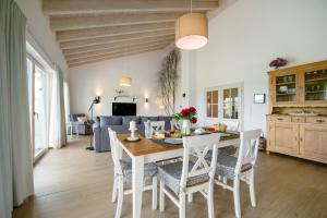 a kitchen and dining room with a table and chairs at Waldwasserhaus Leisel in Leisel