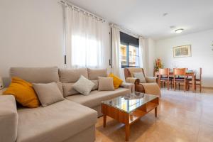 a living room with a couch and a table at Ca la Mercè in Camarles