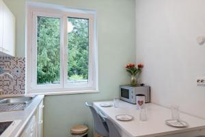 a kitchen with a table with a microwave and a window at Amselnest in Kempten