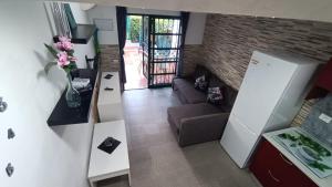 a living room with a couch and a refrigerator at Dunaflor Gemelo 1 in San Bartolomé