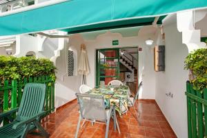 a table and chairs on the balcony of a building at Dunaflor Gemelo 1 in San Bartolomé