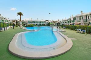 a swimming pool at a resort with condos at Dunaflor Gemelo 1 in San Bartolomé