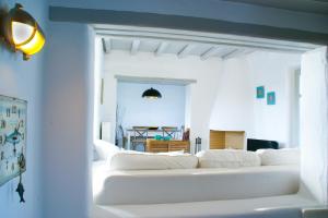 a white living room with white couches at House with private pool in Naousa +16 photos