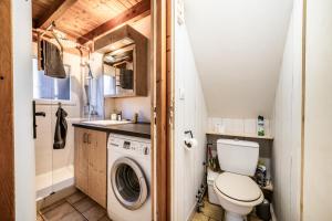 a tiny house with a toilet and a sink at Chalet 6p - Le casse noisette in Verchaix +13 photos