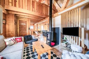 a living room with a couch and a table at Chalet 6p - Le casse noisette in Verchaix