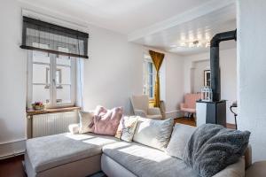 a living room with a white couch and windows at Haus nähe Schweiz in Kandern