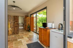 a kitchen with a refrigerator and a counter top at Villa La Mireio in Malaucène +14 photos