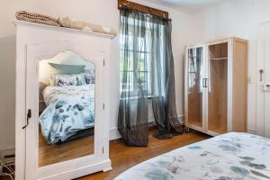 a bedroom with a bed and a mirror at Haus nähe Schweiz in Kandern