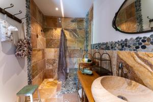 a bathroom with a large wooden sink and a shower at Villa La Mireio in Malaucène