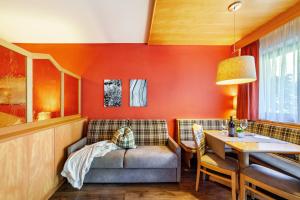 a living room with a couch and a table at Alpenhof Lodge Almrose in Saltusio +24 photos