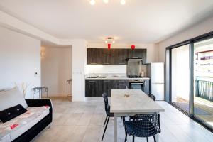a kitchen and living room with a table and a couch at Imarena, Elegance et Vue Port in Capbreton +23 photos