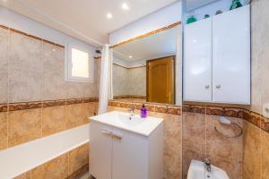 a bathroom with a sink and a shower at Frente al mar in Cala Millor +17 photos