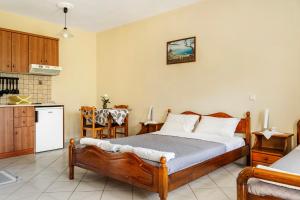 a bedroom with a bed and a kitchen at Daratos studio 4 in Kefallonia